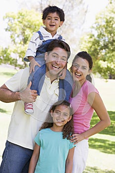 Family outdoors smiling