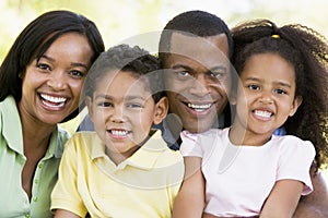 Family outdoors smiling