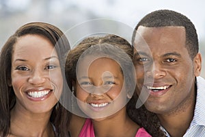 Family outdoors smiling