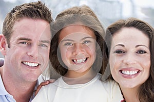 Family outdoors smiling