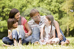 Family outdoors smiling