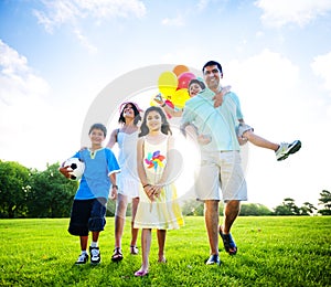 Family In Outdoors Walking Towards A Camera