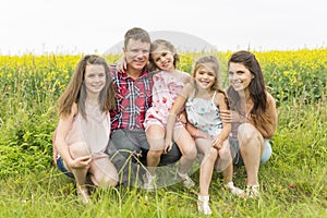 Family outdoors on a yellow field