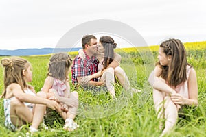 Family outdoors on a yellow field