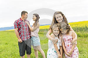 Family outdoors on a yellow field