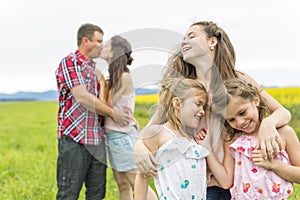 Family outdoors on a yellow field