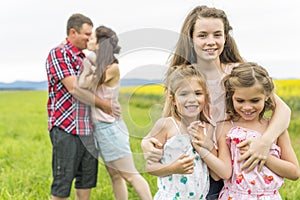 Family outdoors on a yellow field