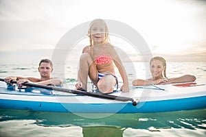 Family with paddle board