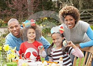 Family Painting Easter Eggs In Gardens