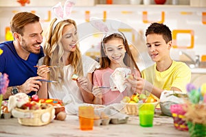 Family painting Easter eggs