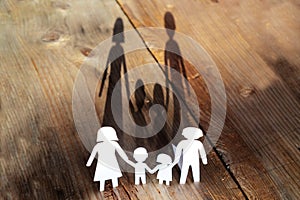 The family of paper cut placed on a wooden table