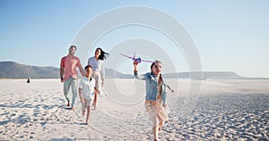 Family, parents and kids on beach with plane for playing, relax and bonding on holiday or vacation. Travel, man and