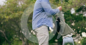Family, park and father spinning child for bonding, relationship and playing together outdoors for fun. Happy, love and