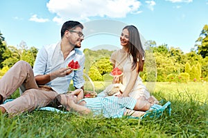 Family In Park. Happy Young Parents And Child Relaxing Outdoors