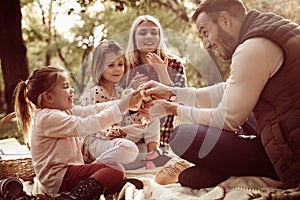 Family in park having picnic.