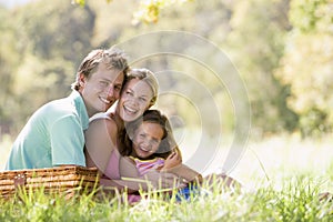 Family at park having a picnic and laughing