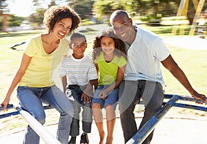 Family In Park Riding On Roundabout