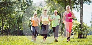Family with personal Fitness Trainer jogging
