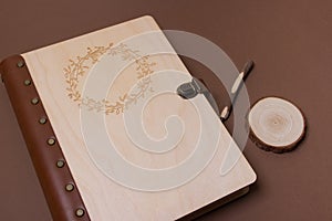 Family photo book with embossing. Brown photo book with wood cover. Wedding photo album with wooden pen