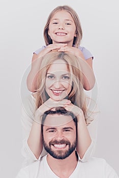 Family photo portrait of three. Parents and small blond daughter