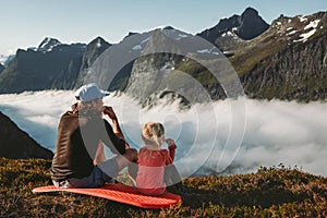 Family picnic father and daughter eating snacks in mountains travel vacations camping outdoor dad with child