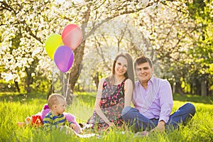 Family picnic. father, mother, child sitting together