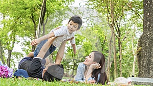 Family Picnic at gaden park Outdoors Togetherness Relaxation Concept with father carrying the kid