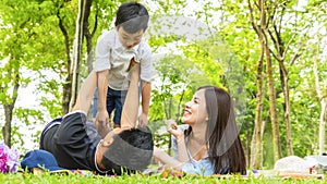 Family Picnic at gaden park Outdoors Togetherness Relaxation Concept with father carrying the kid