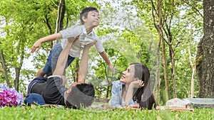 Family Picnic at gaden park Outdoors Togetherness Relaxation Concept with father carrying the kid