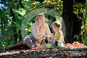 Family picnic. Mothers day. Mother love her small boy child. Spring mood. Happy family day. Sunny weather. Healthy food