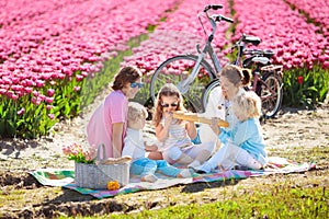 Family picnic at tulip flower field, Holland