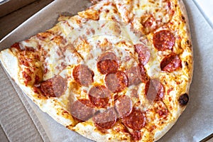 Family pizza, half of oval, consists of two types, margarita, pepperoni. Food delivery concept, takeaway, Italian cuisine, fast