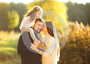 Family playing in autumn park having fun