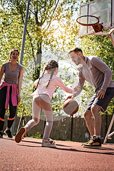 Family playing basketball.