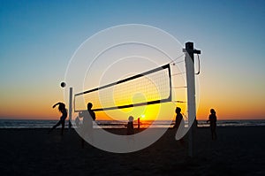 Family playing beach volleyball