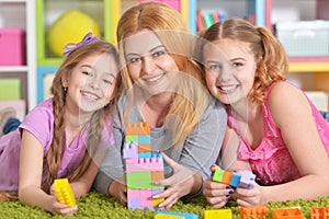 family playing with blocks together photo