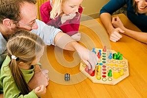 Family playing a board game