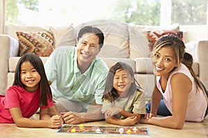 Family Playing Board Game At Home