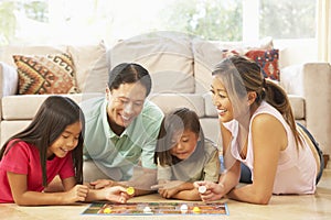 Family Playing Board Game At Home