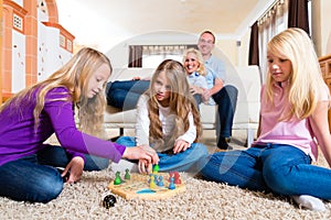 Family playing board game at home