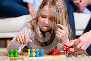 Family playing board game at home