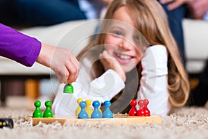 Family playing board game at home