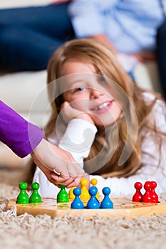 Family playing board game at home