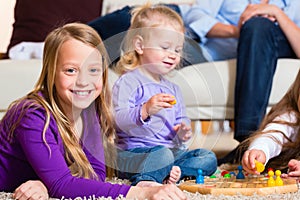 Family playing board game at home