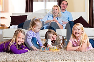 Family playing board game at home