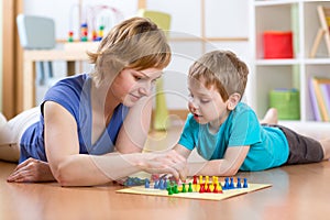 Family playing board game at home on the floor at home