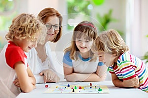 Family playing board game. Kids play