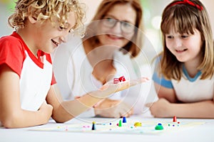 Family playing board game. Kids play