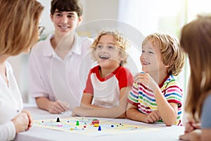 Family playing board game. Kids play