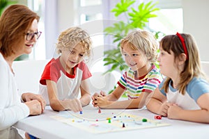 Family playing board game. Kids play